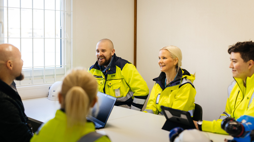 Employees talking around table